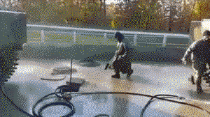 Man dancing over a water hose