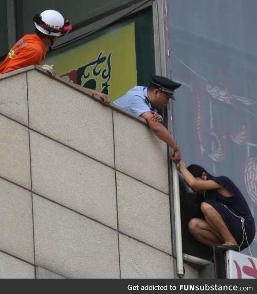 Beijing cop handcuffs himself to suicidal woman on ledge to save her life