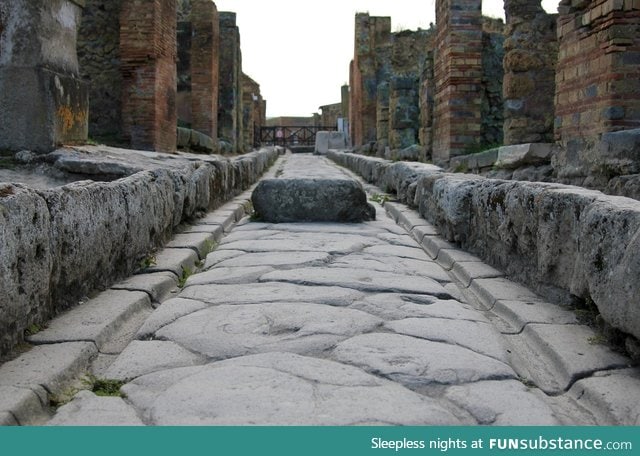 Stone street in Pompeii with tracks for chariot wheels
