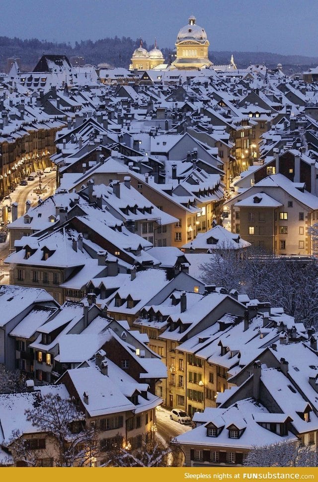 Snowy rooftops and well lit streets in Bern, Switzerland. Beautiful