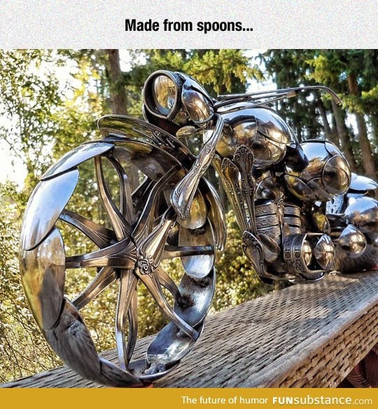 A motorcycle sculpture made entirely out of spoons