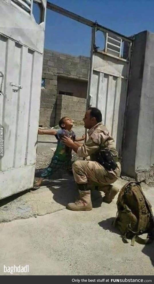 Iraqi child trying to stop his father from leaving the house to fight ISIS