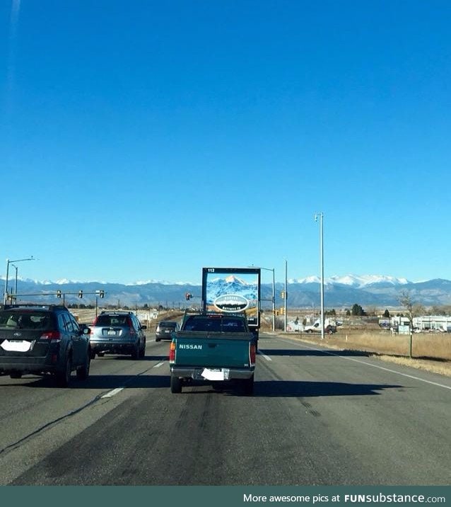Truck lines up with Rocky Mountains