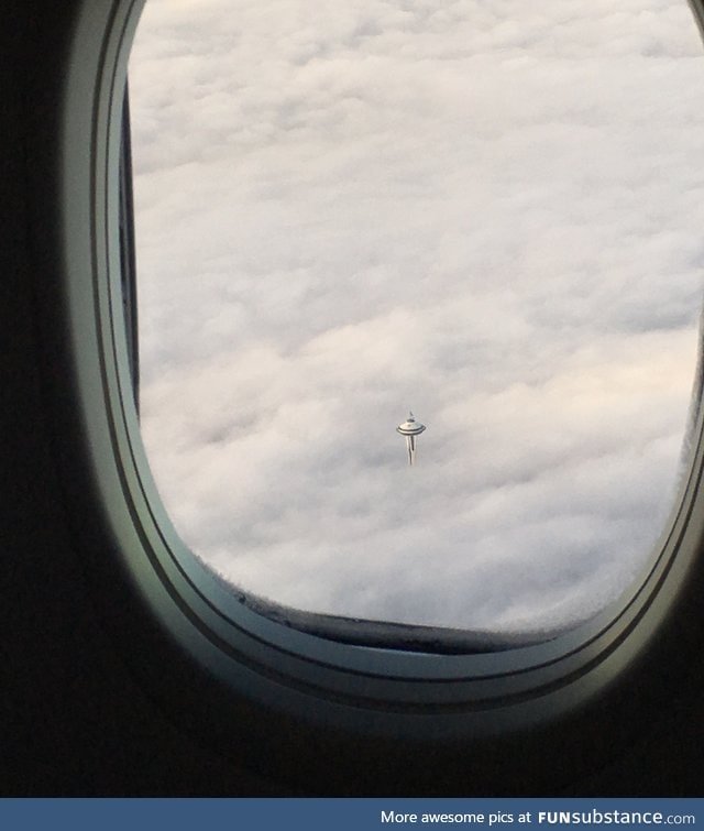Space Needle in Seattle over clouds looks like the cloud city from Star Wars