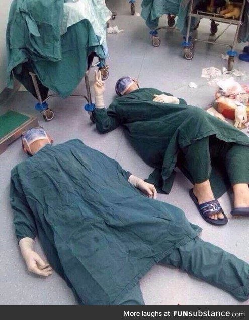 2 surgeons after successfully removing a set of brain tumors during a 32 hour surgery