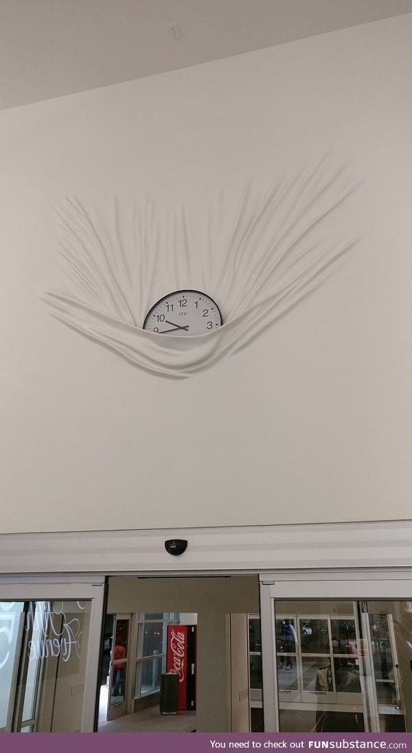 Clock weighing down paint on the wall
