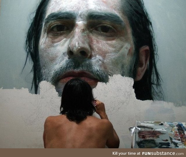 Artist paints photorealistic portrait of himself covered in paint