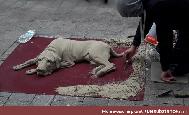 This dog made out of sand. (Germany, Flensburg)