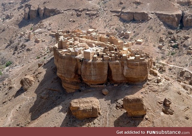 A village in Yemen basically built on top of a huge rock