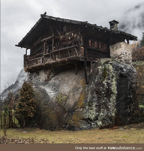 Old wooden house on a giant rock