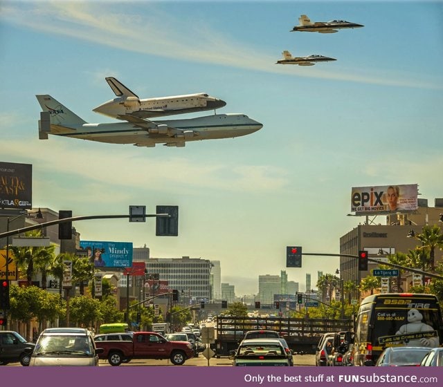 The space shuttle being carried by a 747 and escorted by two F-18's