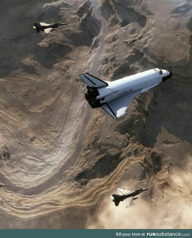 Space shuttle escorted by fighter jets