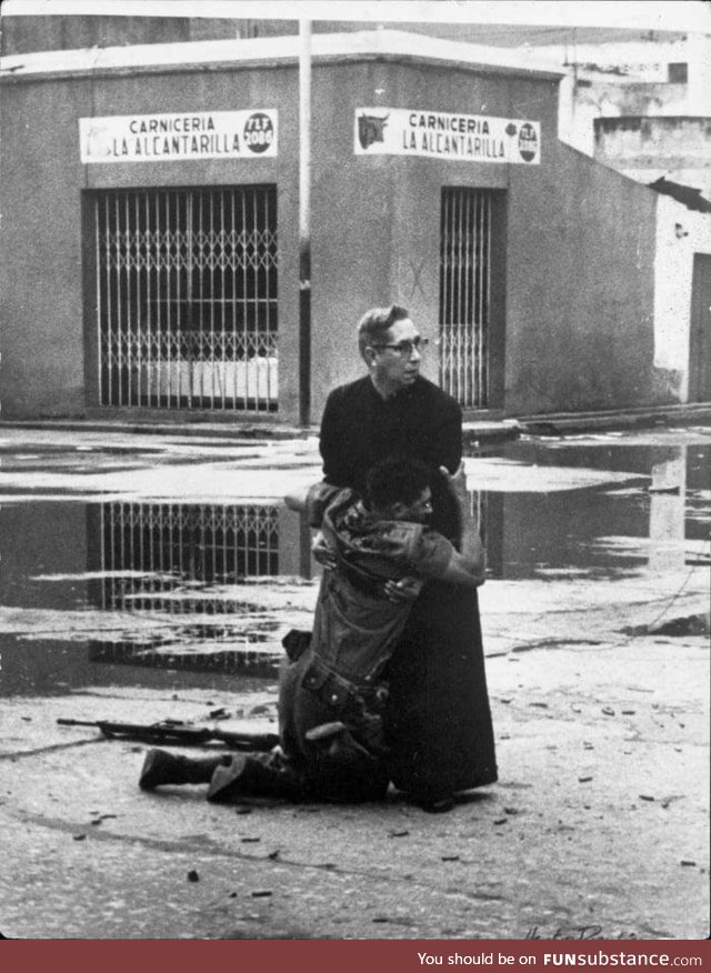 A priest consoling a dying soldier ad they are surrounded by snipers. Venezuela 1962