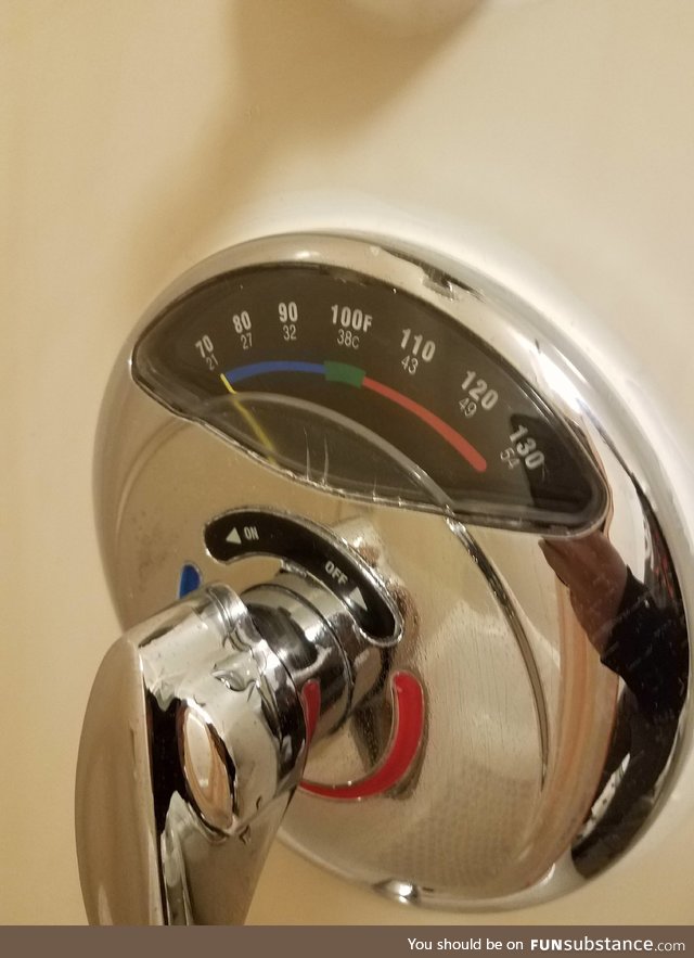 This shower at a hotel has a thermometer