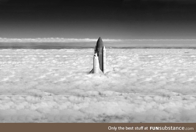 The space shuttle breaking through the clouds