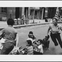 A police officer playing with children in New York, 1970