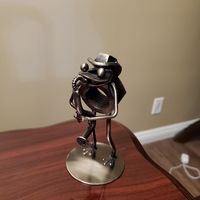My husband's customer made him a little frog playing an instrument, using materials my