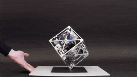 A swiss-engineered cube that can balance itself on its own corner