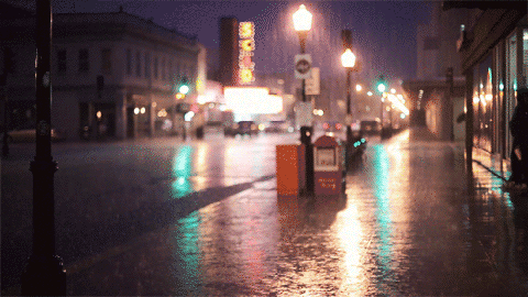 Cinemagraph of rain dribbling in front of neon lights