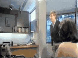 Bill Gates jumping over a chair.
