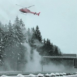 Helicopter removing snow from trees along the Autobahn