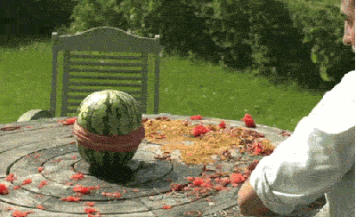 Rubber bands splitting a watermelon