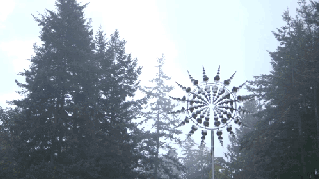 Wind-powered metal sculpture in a forest (it is real, no cgi)
