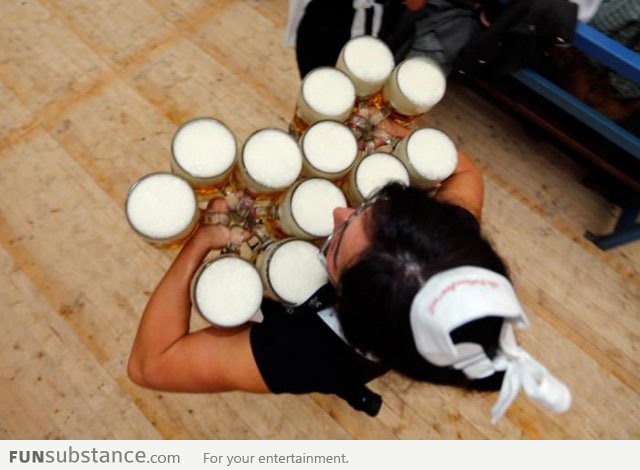 An Oktoberfest waitress carries 6 liters of beer in each han