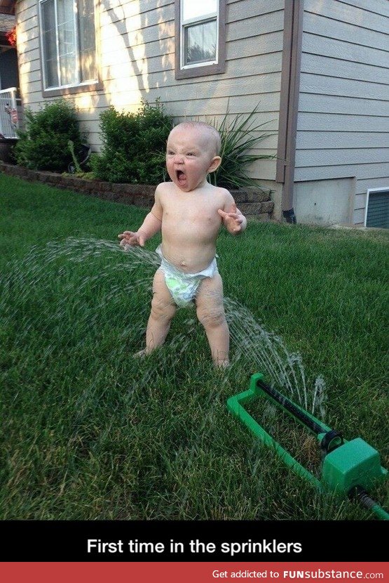 Baby meets sprinklers