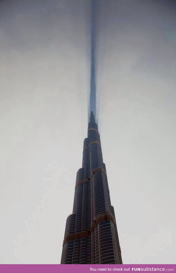 Cloud cut in half by Burj Khalifa