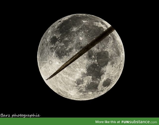 A photographer was preparing to shoot the lunar eclipse when a plane came by
