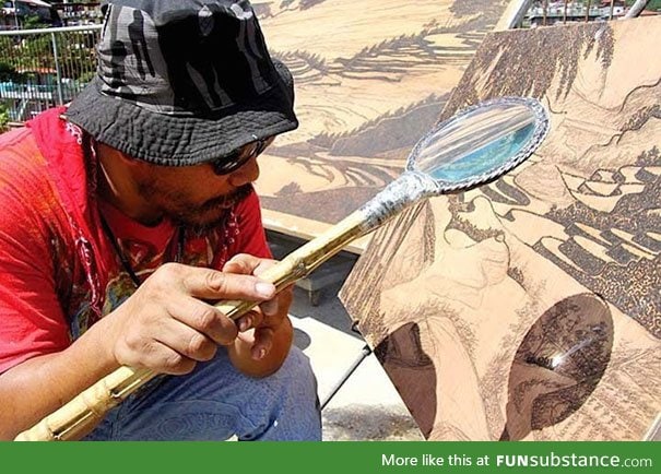 Artists uses the sun and magnifying glass to create intricate works of art