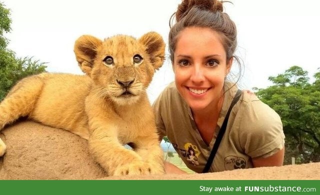 Takes picture with lion cub, manages to be cutest one in the photo