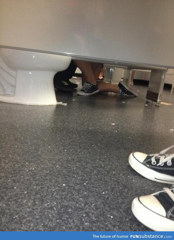A woman proposing to a guy in a bathroom, aww