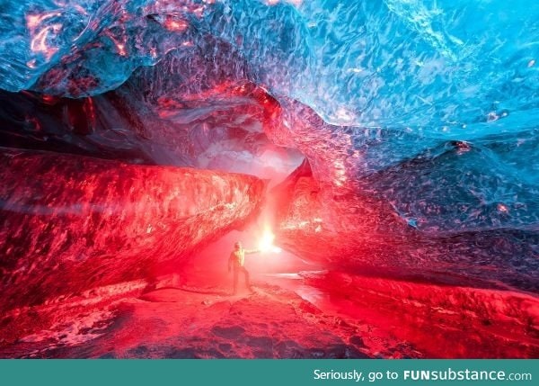 An Icelandic ice cave, lit up by a burning flare -- photo by Brynjar Ágústsson