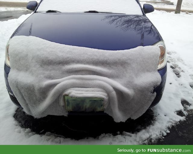 Snow slipping off of a car's hood