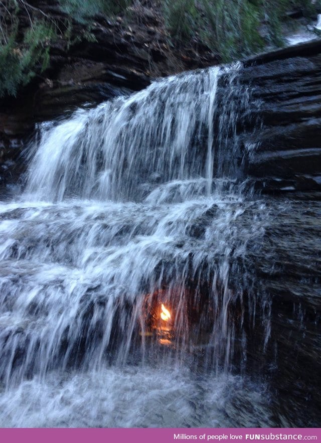 Eternal flame. This natural methane vent creates a flame under a waterfall