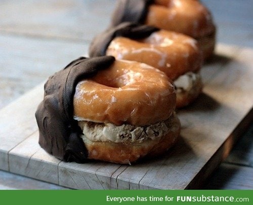 Glazed donuts stuffed with chocolate chip cookie dough hand dipped in chocolate