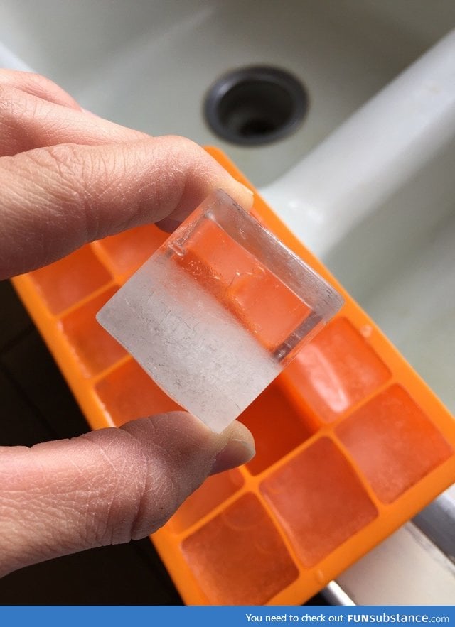 The ice cube is half transparent, half opaque