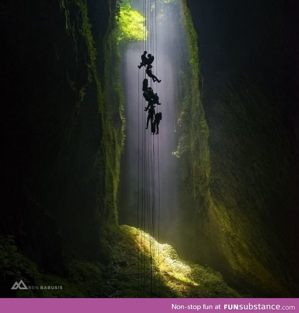 A team of explorers abseils 100m down into the magical Lost World Cave in New Zealand