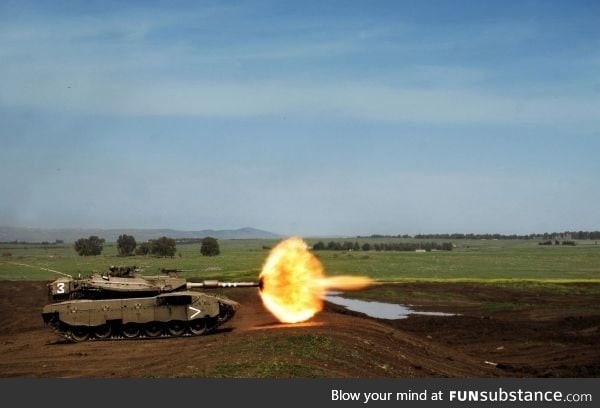 Perfectly timed photo of a tank firing the main gun