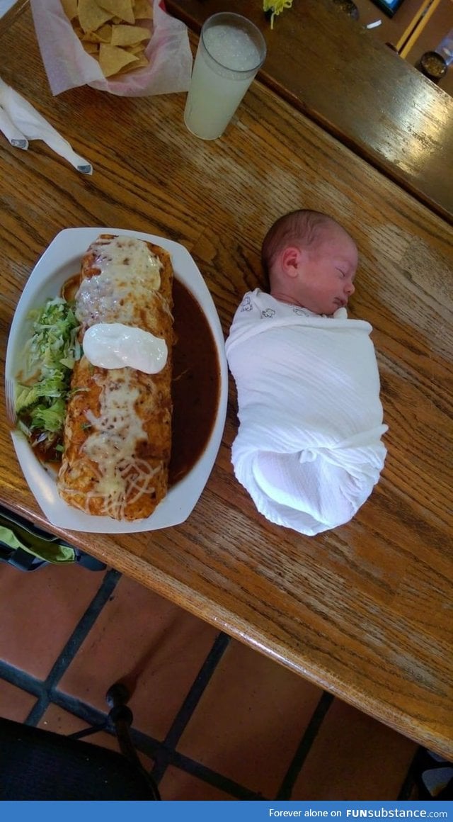 Baby burrito-ed next to a baby sized burrito for scale