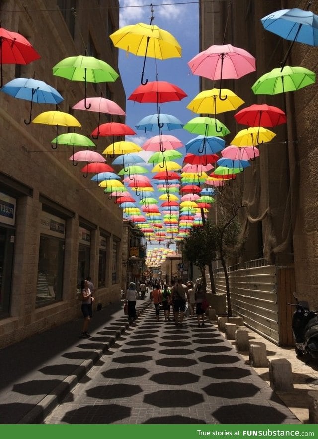 Umbrellas suspended over a side street in Jerusalem