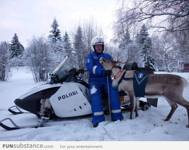 Policeman with his police reindeer in Finland