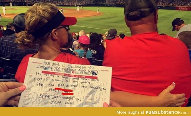 Person notices a wife sexting with another man at a ball game. Hands husband warning note