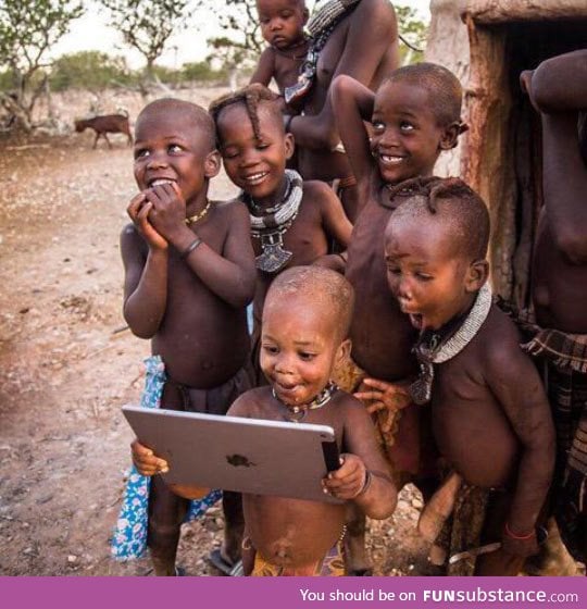 Tribal children see a ipad for the first time