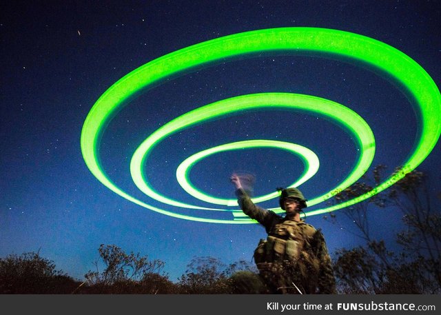 US Marine uses string of chem lights to signal landing zone for V-22 Osprey