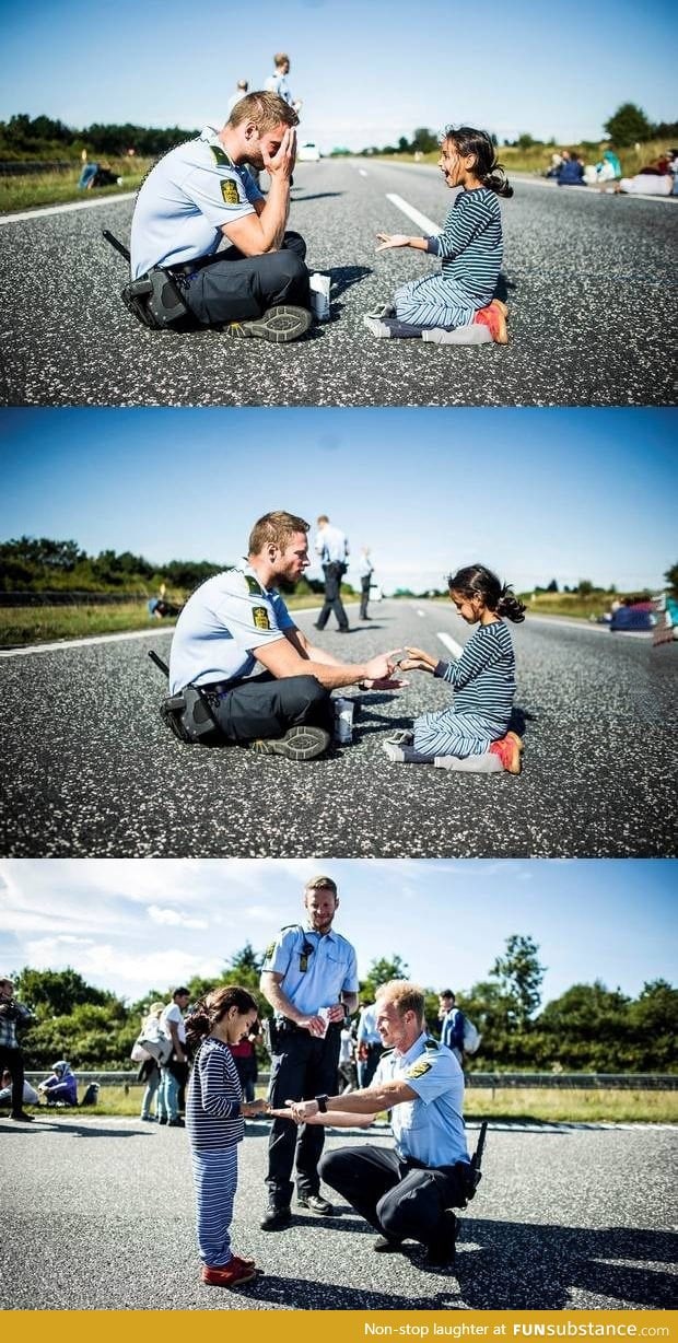 Danish officer playing with Syrian refugee girl