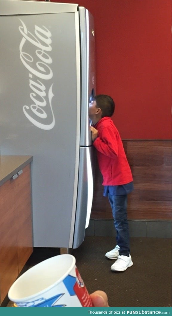 This kid was drinking soda straight from the dispenser