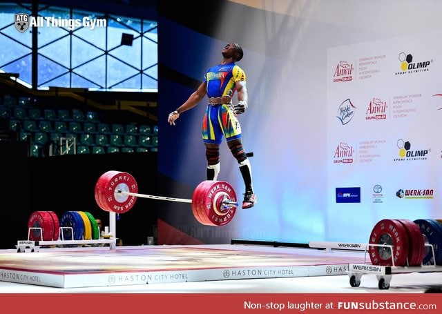 Weightlifter jumping up after a successful lift